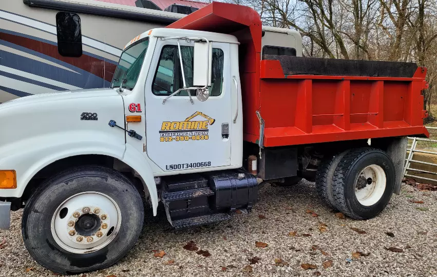 Need a load of sand, gravel, topsoil, mulch, or other material delivered to or from your location? Romine Excavating & Septic based out of Hope, Indiana is ready for anything with our Single and Tandem Axle Dump Trucks!